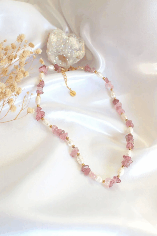 Close-up of a handcrafted choker necklace featuring natural Strawberry Quartz crystals and white freshwater pearls, with an 18K gold-plated adjustable clasp.
