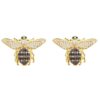 Close-up of 18K gold plated Honey Bee stud earrings with detailed wings and a polished finish, displayed on a soft neutral background.