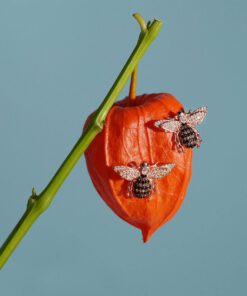 Close-up of 18K gold plated Honey Bee stud earrings with detailed wings and a polished finish, displayed on a soft neutral background.
