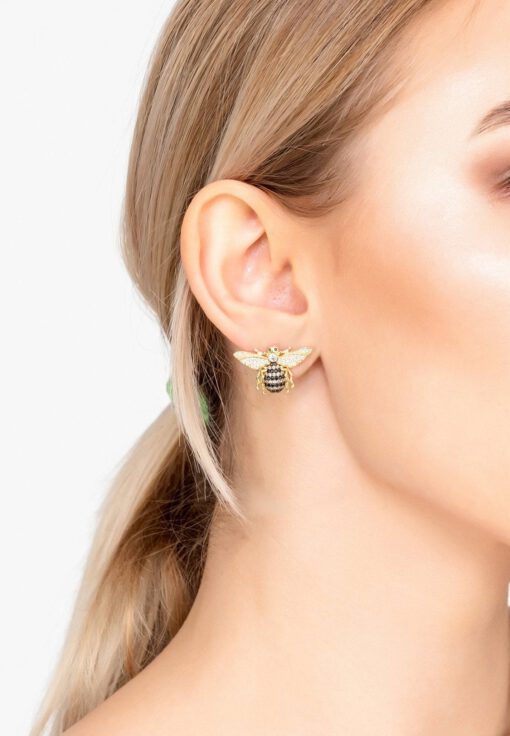 Close-up of 18K gold plated Honey Bee stud earrings with detailed wings and a polished finish, displayed on a soft neutral background.