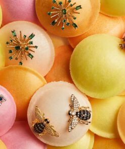 Close-up of 18K gold plated Honey Bee stud earrings with detailed wings and a polished finish, displayed on a soft neutral background.