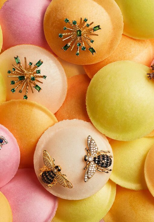 Close-up of 18K gold plated Honey Bee stud earrings with detailed wings and a polished finish, displayed on a soft neutral background.