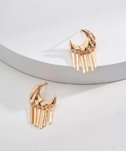 Gold moon tassel earrings with celestial design, displayed on minimal background.