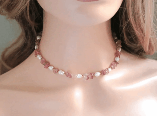 Close-up of a handcrafted choker necklace featuring natural Strawberry Quartz crystals and white freshwater pearls, with an 18K gold-plated adjustable clasp.