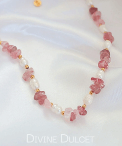 Close-up of a handcrafted choker necklace featuring natural Strawberry Quartz crystals and white freshwater pearls, with an 18K gold-plated adjustable clasp.