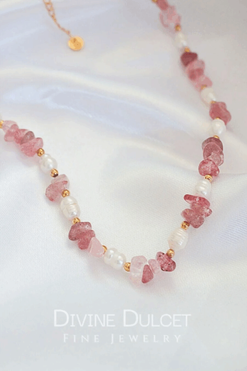 Close-up of a handcrafted choker necklace featuring natural Strawberry Quartz crystals and white freshwater pearls, with an 18K gold-plated adjustable clasp.