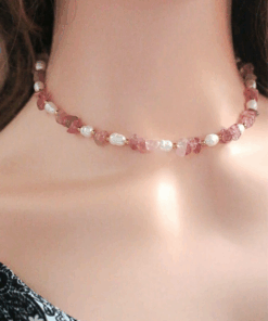 Close-up of a handcrafted choker necklace featuring natural Strawberry Quartz crystals and white freshwater pearls, with an 18K gold-plated adjustable clasp.