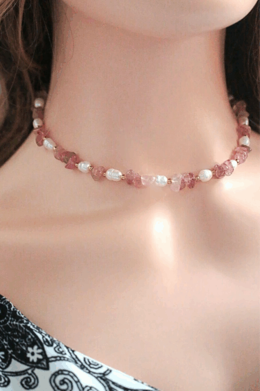 Close-up of a handcrafted choker necklace featuring natural Strawberry Quartz crystals and white freshwater pearls, with an 18K gold-plated adjustable clasp.