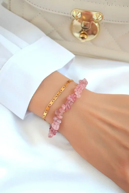 Double-layered Strawberry Quartz bracelet with 24K gold accents styled on a neutral background.
